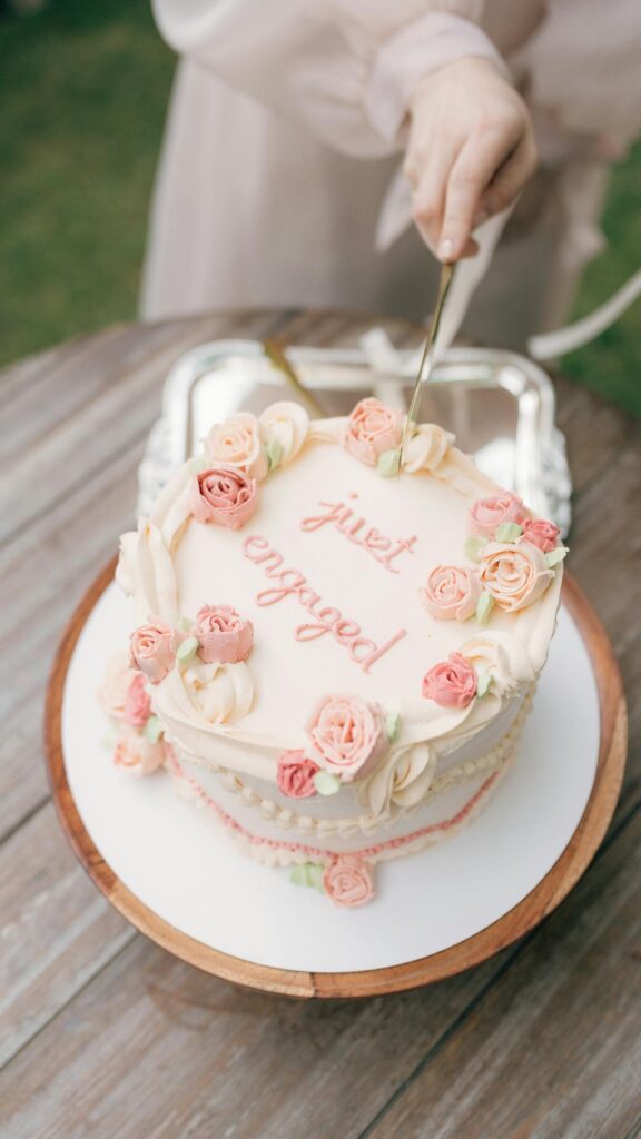 Person Cutting an Engagement Cake
