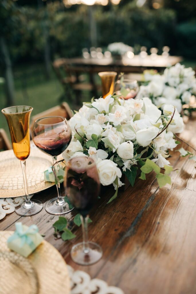 Wineglasses and a Bouquet of Flowers on a Banquet Table
